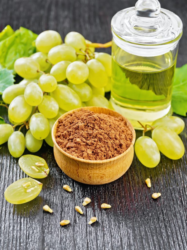 Flour grape seed in bowl on wooden table