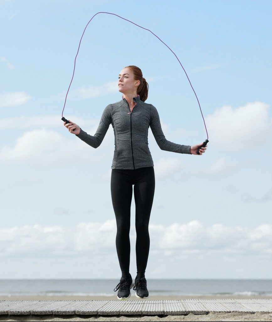 Healthy young woman with jump rope